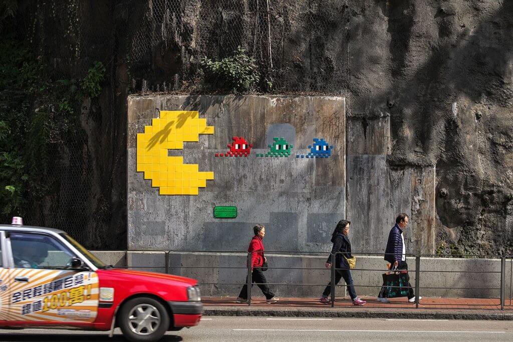 Invader’s pixelated ceramic mosaics turn public space into a global game of discovery, mapping and participation.