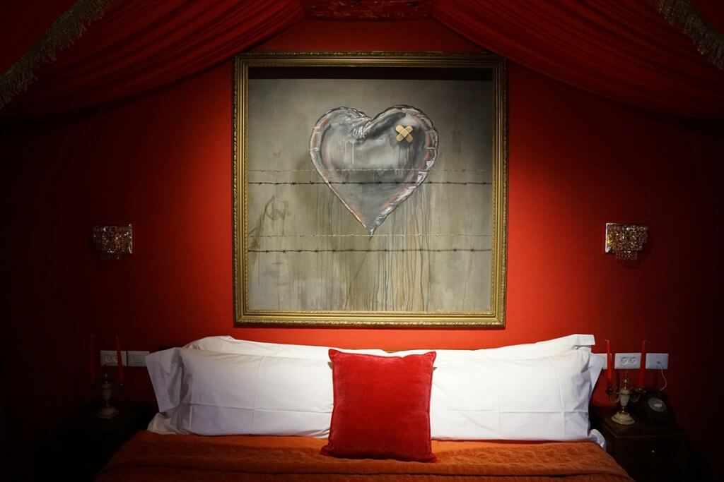 Banksy Love Hurts artwork above the bed in the Walled Off Hotel Presidential Suite