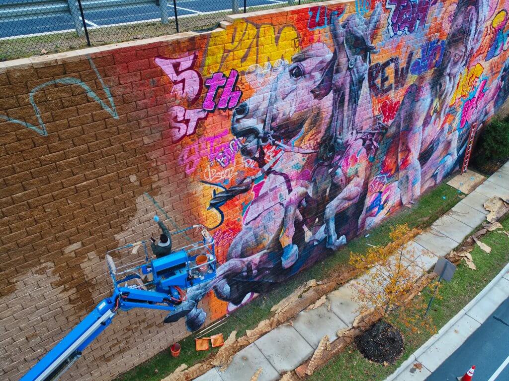 PichiAvo, Street Art Mural "Rivanna River by Poseidon", 5th Street Station, Charlottesville, Virginia 2017. Photo Credit @skycladaerial