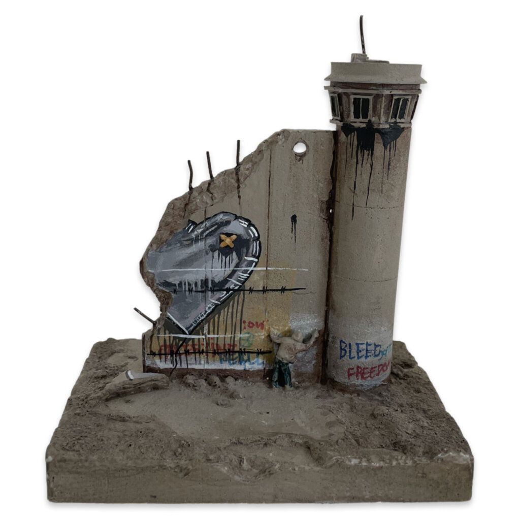 Banksy Love Hurts Walled Off Hotel sculpture with silver heart balloon and barbed wire