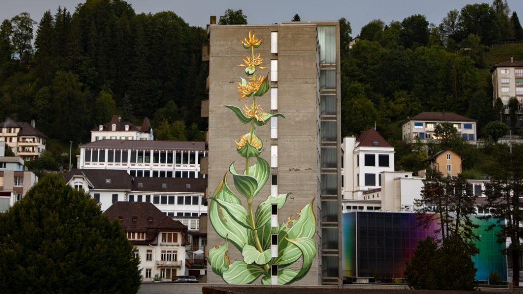 Mona Caron Weeds Project mural in an urban setting