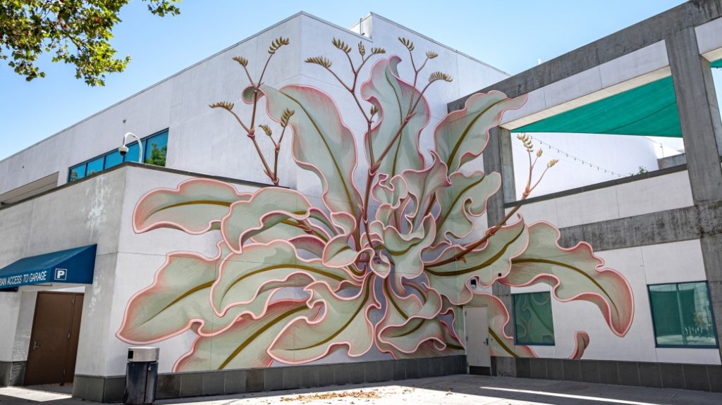 Mona Caron Weeds Project mural in an urban setting