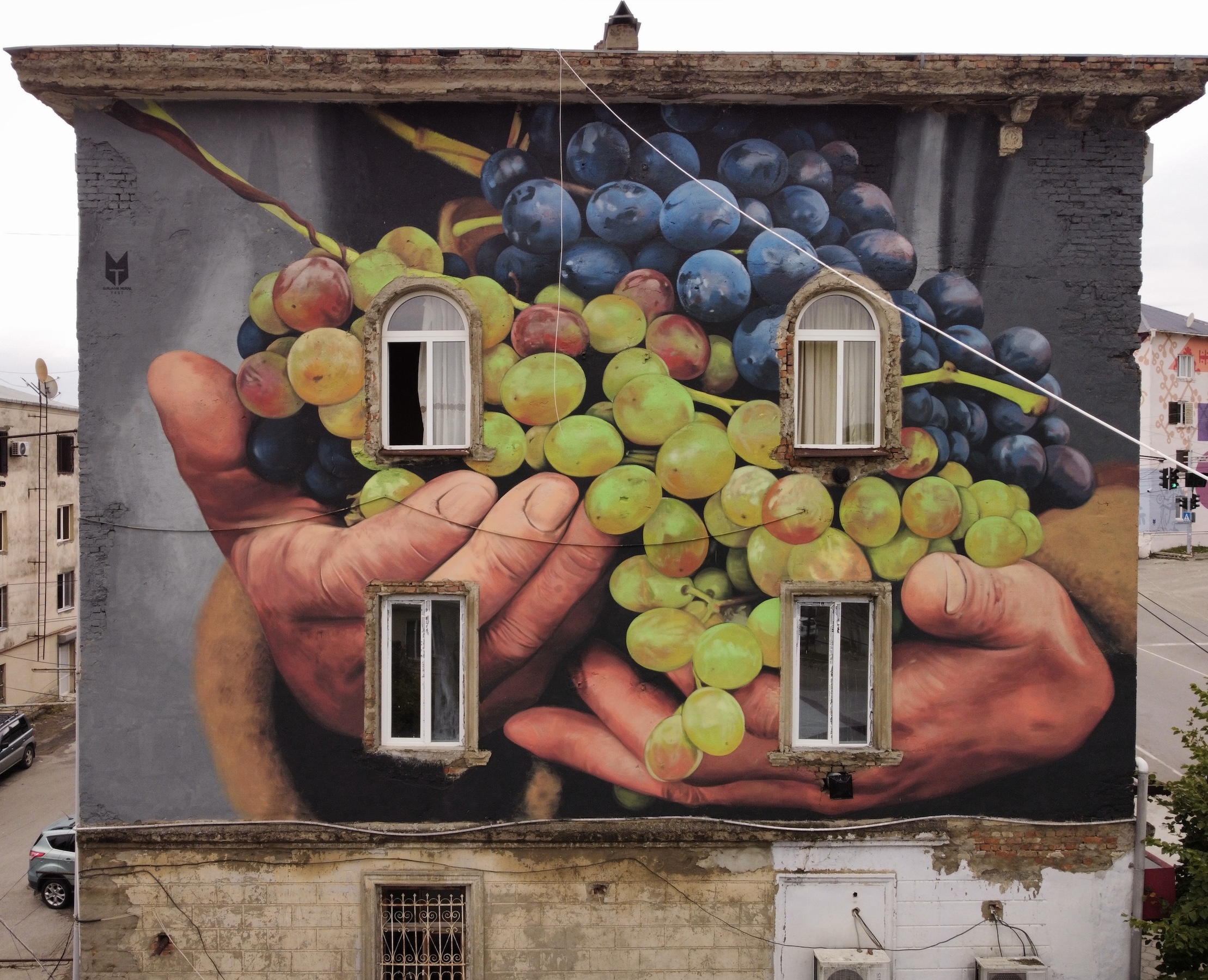 TMF Studio mural referencing Georgian winemaking traditions at Tbilisi Mural Fest 2025 in Gurjaani