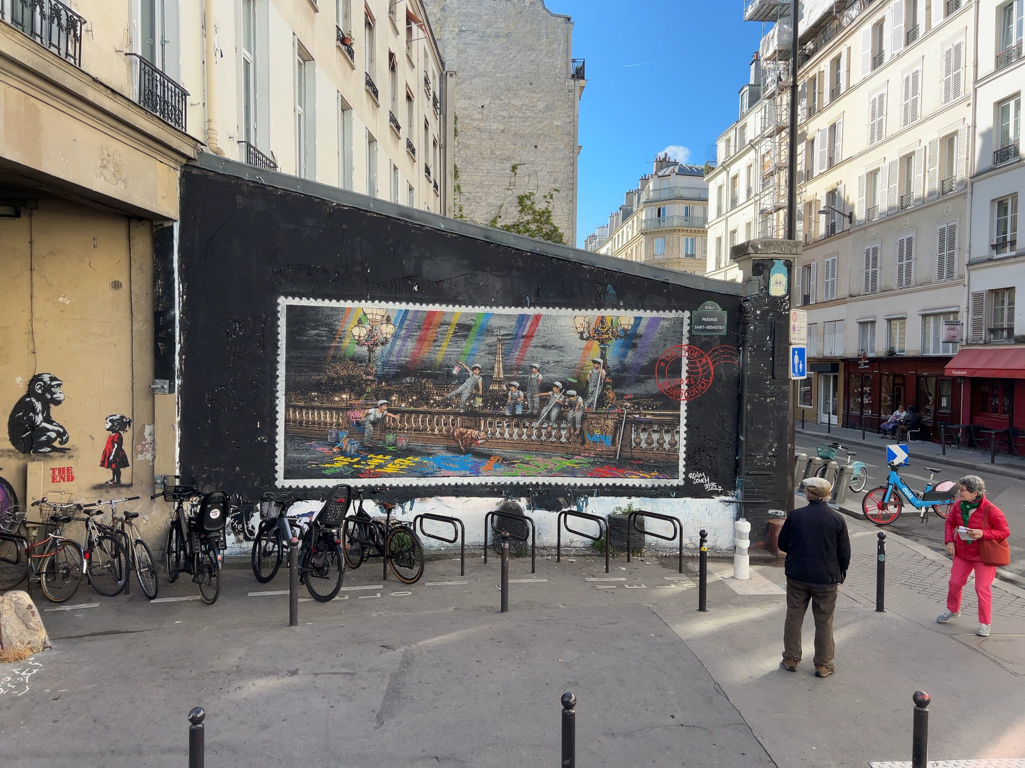 RoamCouch Rainbow Inc mural in Paris postcard-style street art