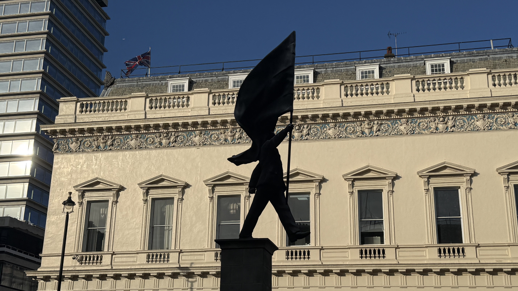 New Banksy Waterloo Place statue detail showing suited figure mid stride at edge of plinth London 2026
