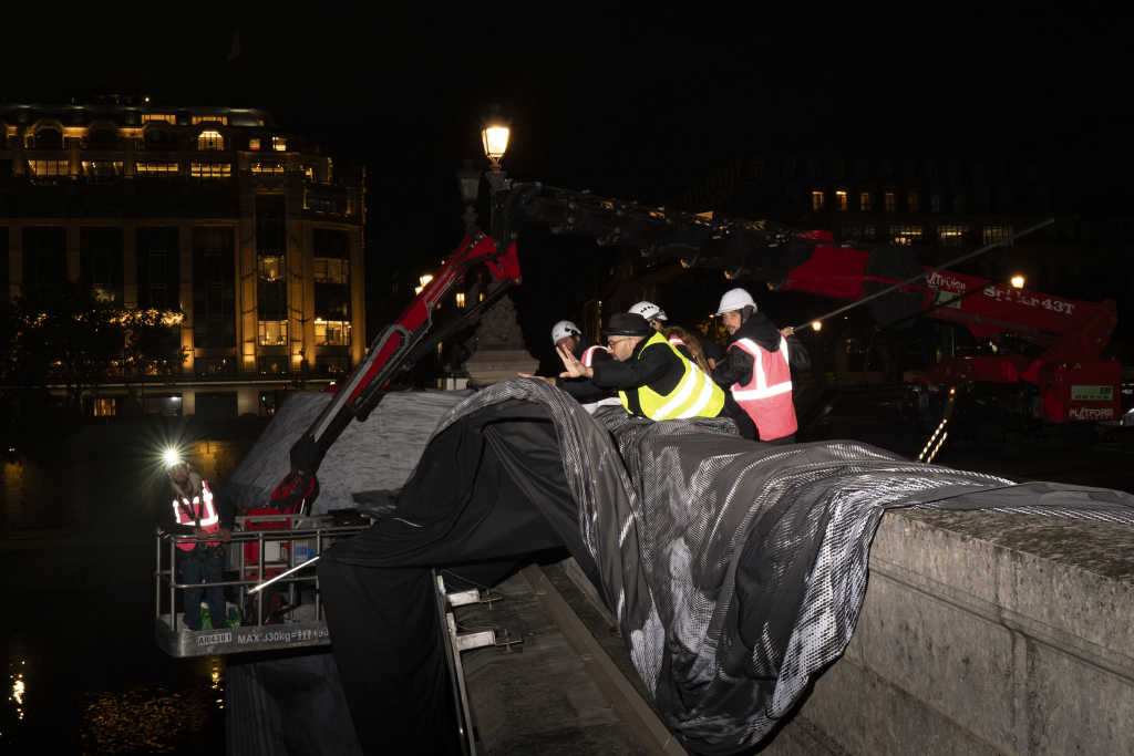 JR Pont Neuf Paris, artist JR and the installation team working through the night to erect La Caverne du Pont Neuf on the Pont Neuf bridge, Paris, May 2026.