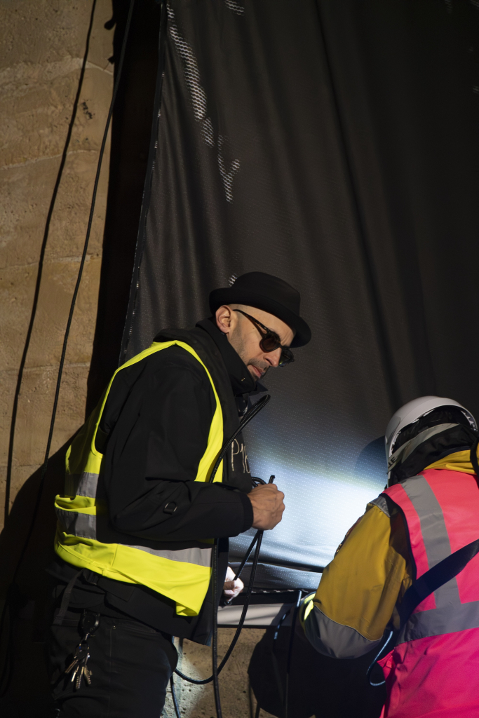 JR Pont Neuf Paris, artist JR pictured during the overnight installation of La Caverne du Pont Neuf on the Pont Neuf bridge, Paris, May 2026.