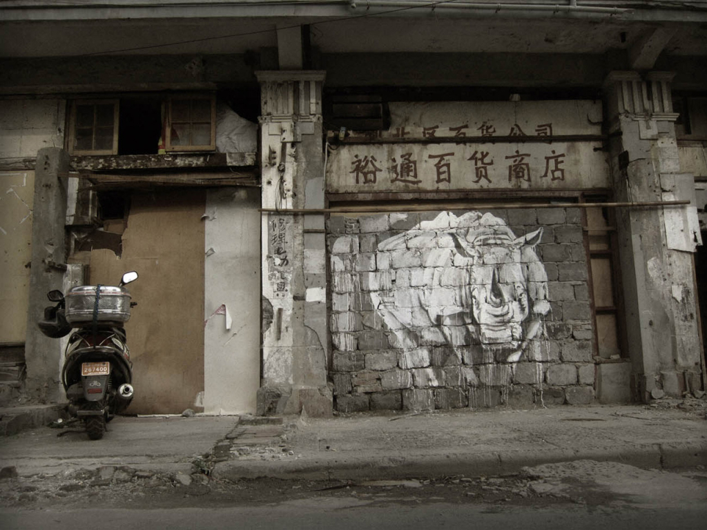 Faith47 rhino mural on abandoned Shanghai wall for World Rhino Day
